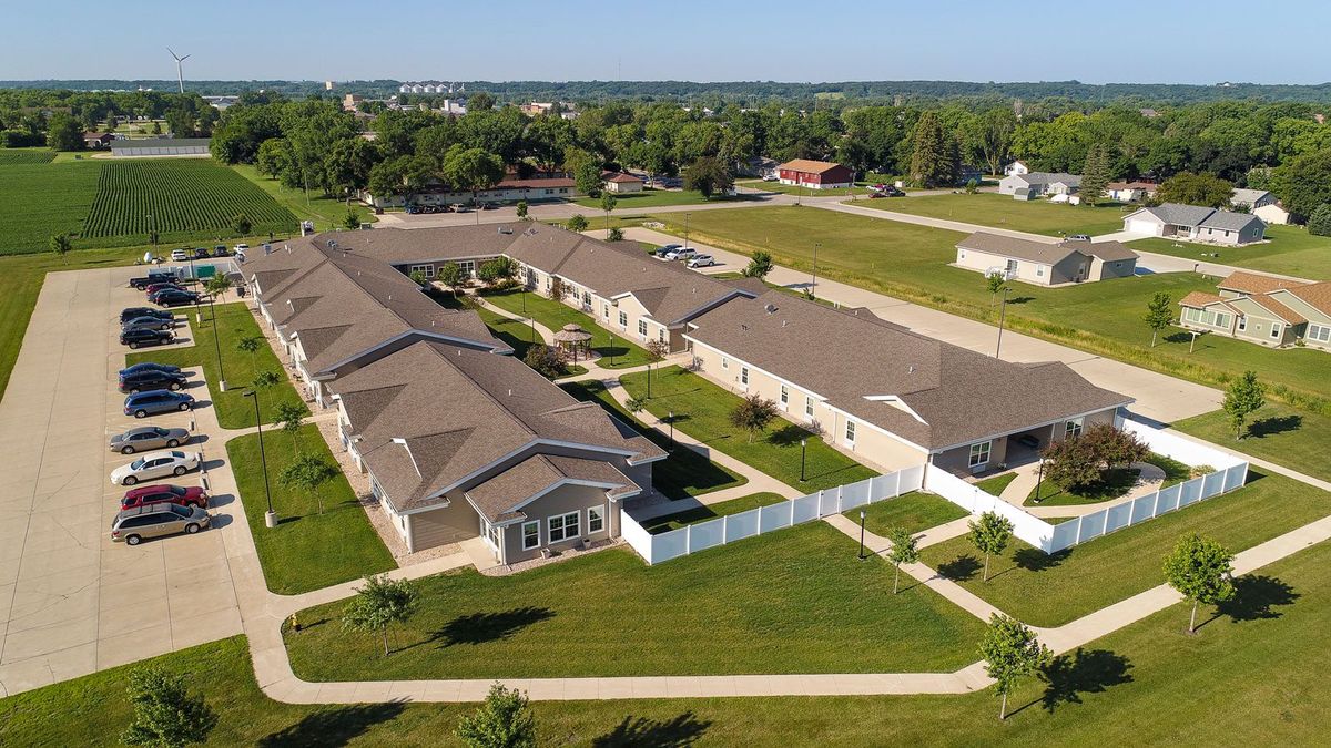Aerial view of a suburban housing complex with expansive green spaces.