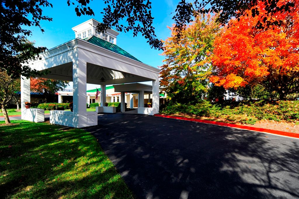 A building entrance surrounded by vibrant autumn foliage.
