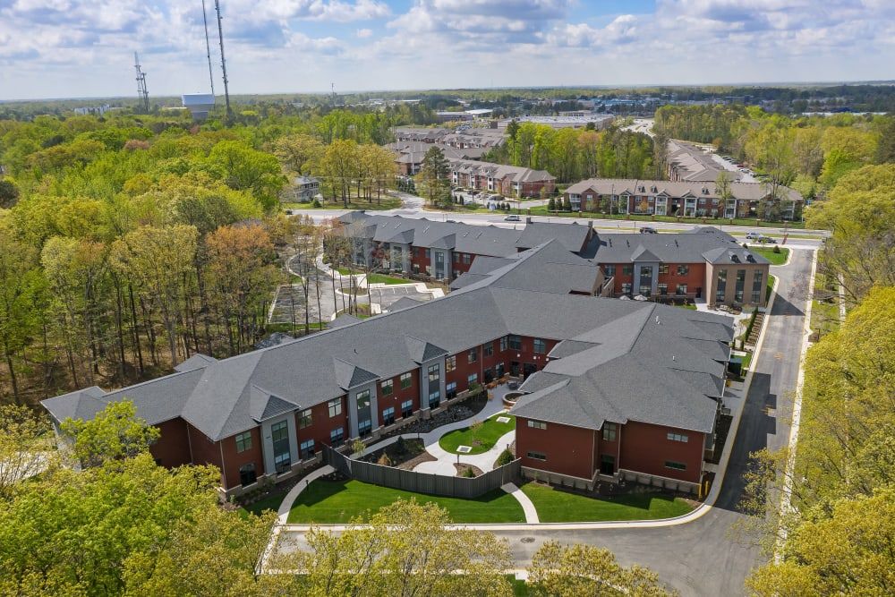 Aerial view of residential buildings surrounded by trees and greenery.