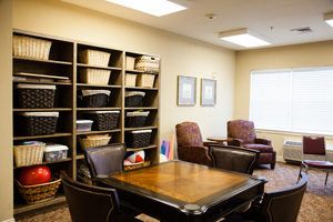 A well-organized office space with comfortable chairs and shelves filled with files.
