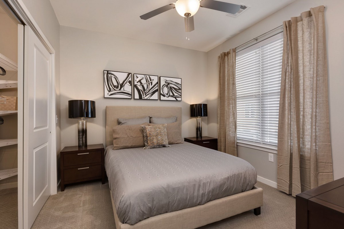 A modern bedroom featuring a neutral color scheme with a comfortable bed, stylish nightstands, and contemporary artwork.