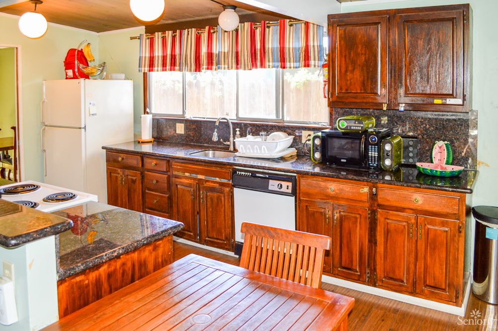 A cozy kitchen with wooden cabinets and modern appliances.