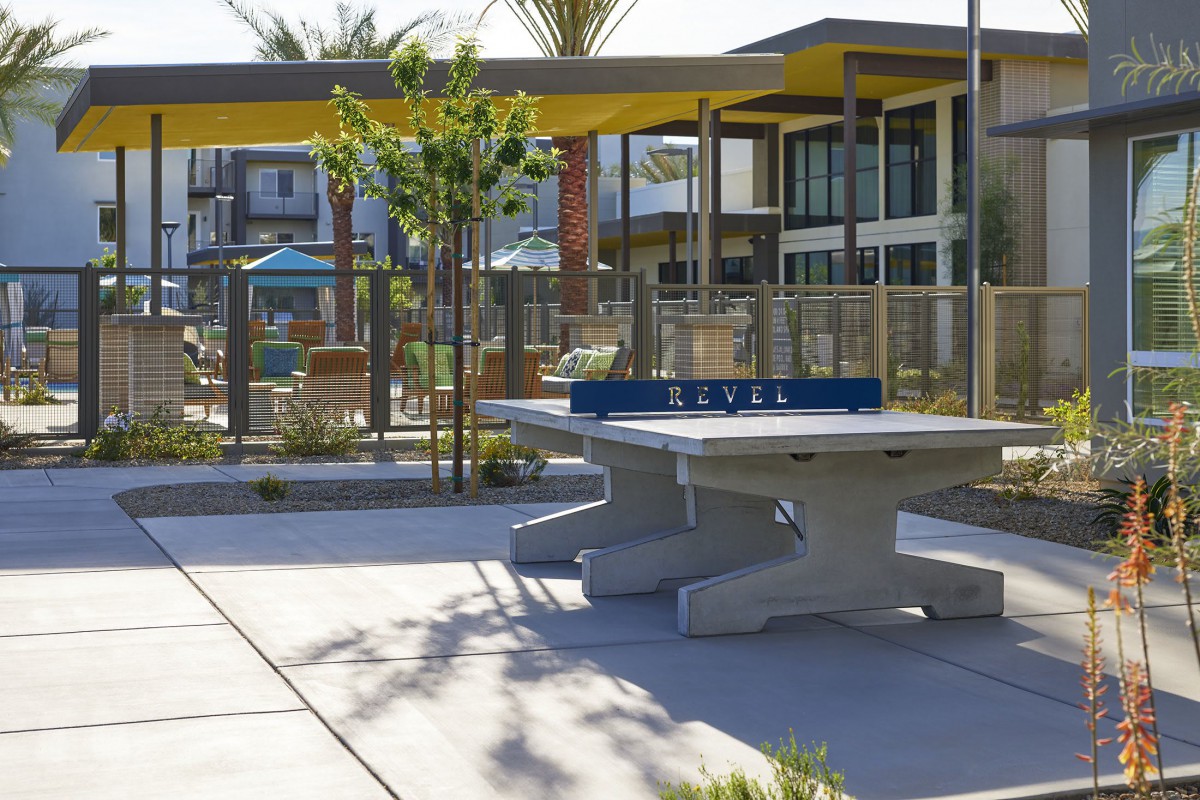 A modern outdoor recreational area featuring a table tennis setup and contemporary architecture.