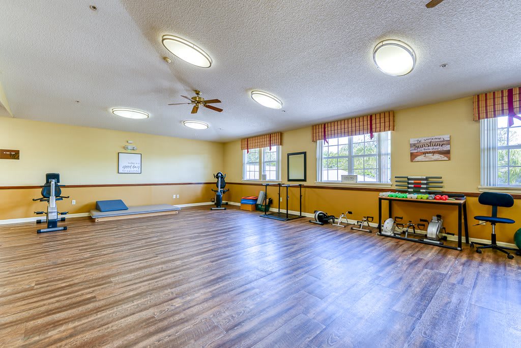 Spacious exercise room with yoga mats and fitness equipment.