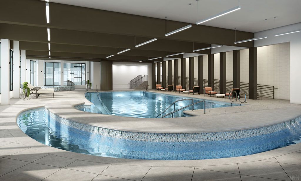 A modern indoor swimming pool with elegant design and seating area.