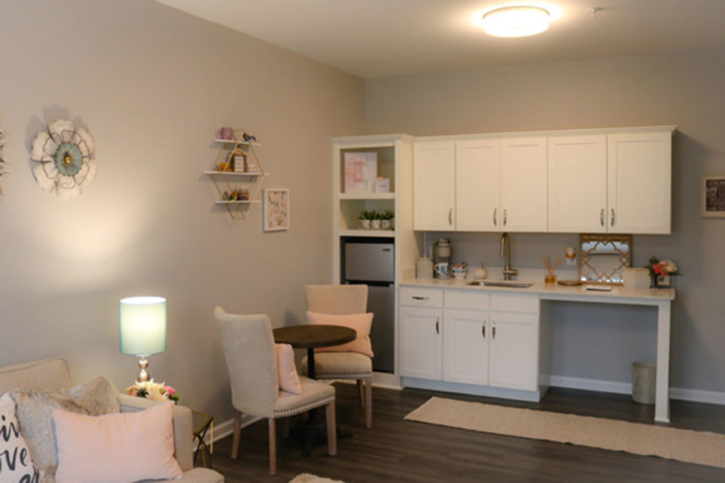A cozy living space with a small kitchenette and dining area.