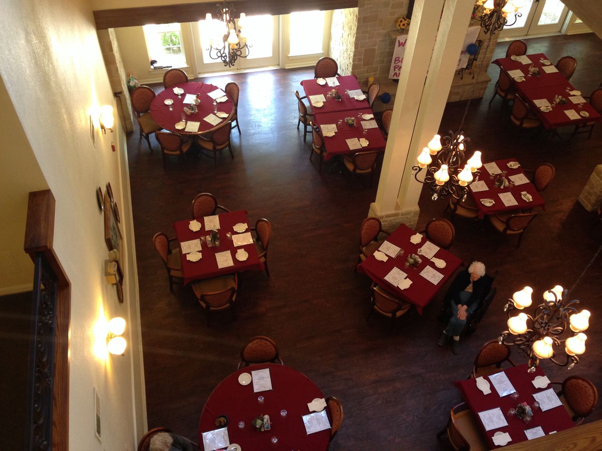 An overhead view of an elegant restaurant dining area with tables set for guests.