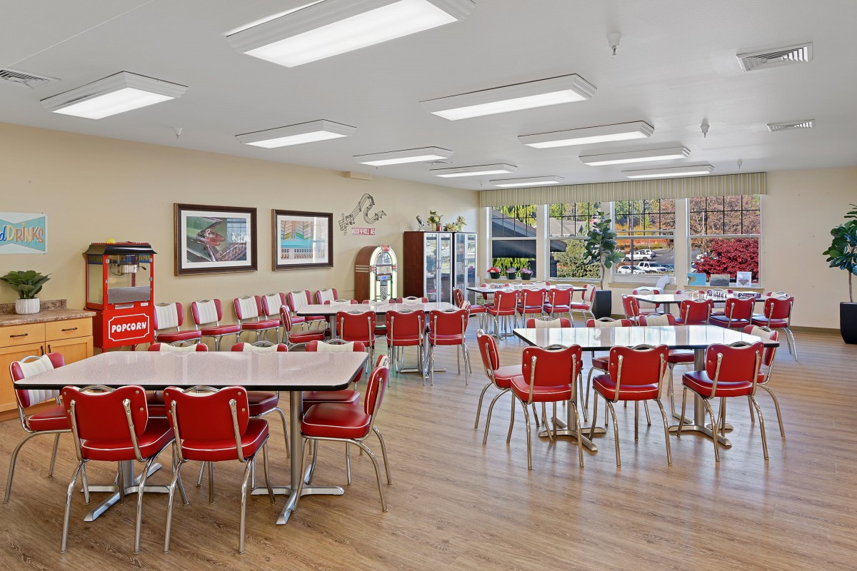 A retro-themed diner with red chairs and checkerboard table tops.