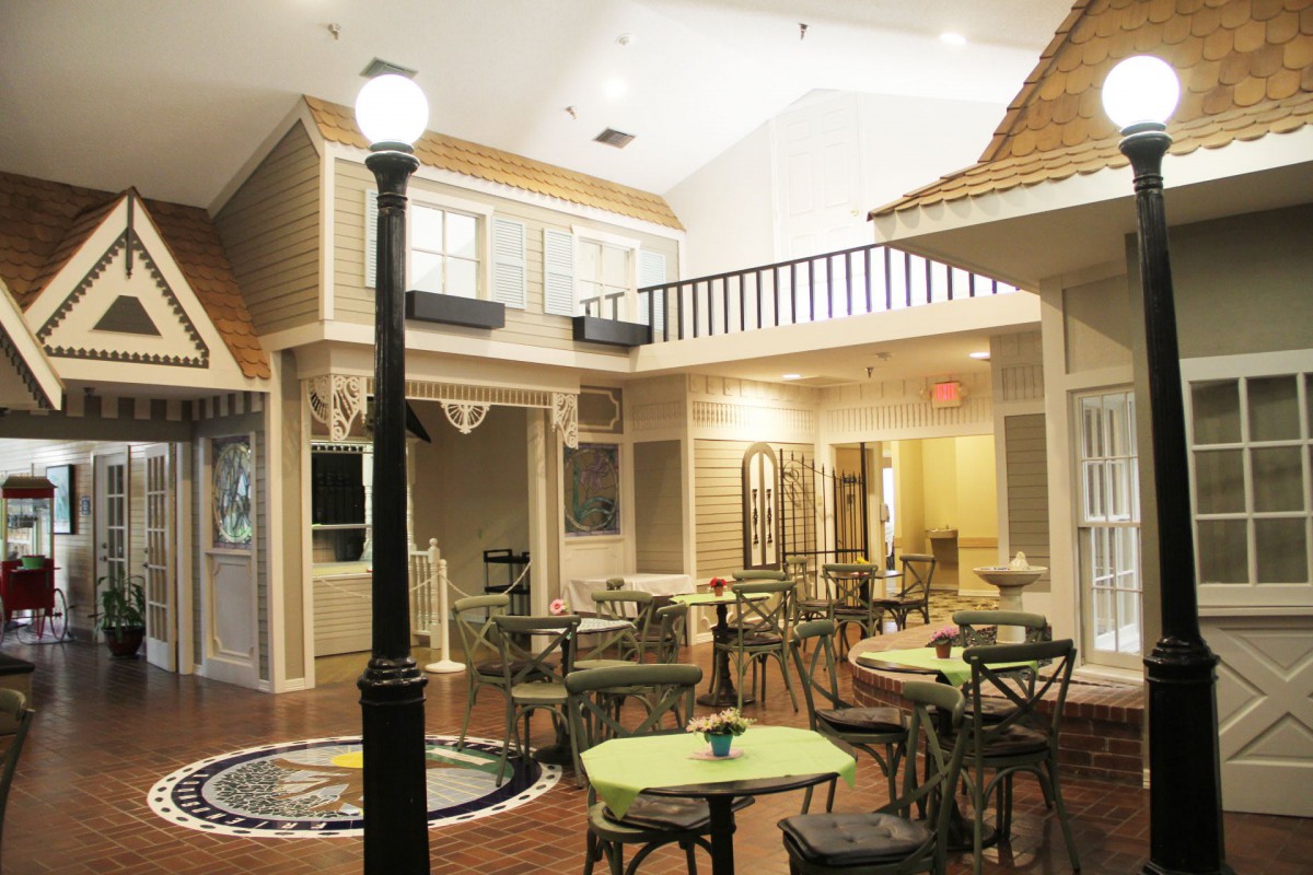 A cozy indoor cafe setting with tables, chairs, and a street-style lamppost.