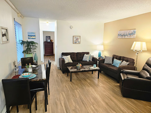 A modern living room featuring comfortable seating and a cozy dining area.