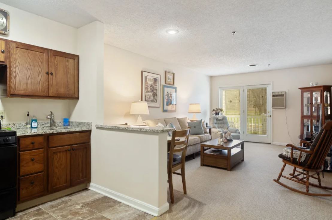 A cozy living space featuring an open floor plan with a blend of modern decor and warm lighting.