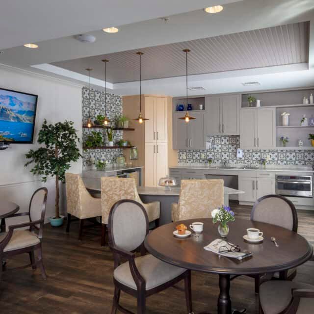 A modern kitchen and dining area with stylish furnishings and contemporary lighting.