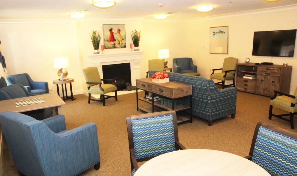 A cozy living room with comfortable seating and a fireplace adorned with decorative items.
