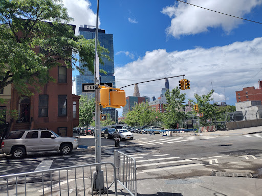 A city intersection showcasing urban life with buildings and traffic.