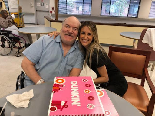 A joyful moment shared over a Dunkin' cake.