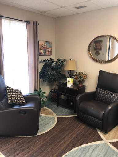 A cozy corner of a living room featuring comfortable seating and decorative elements.