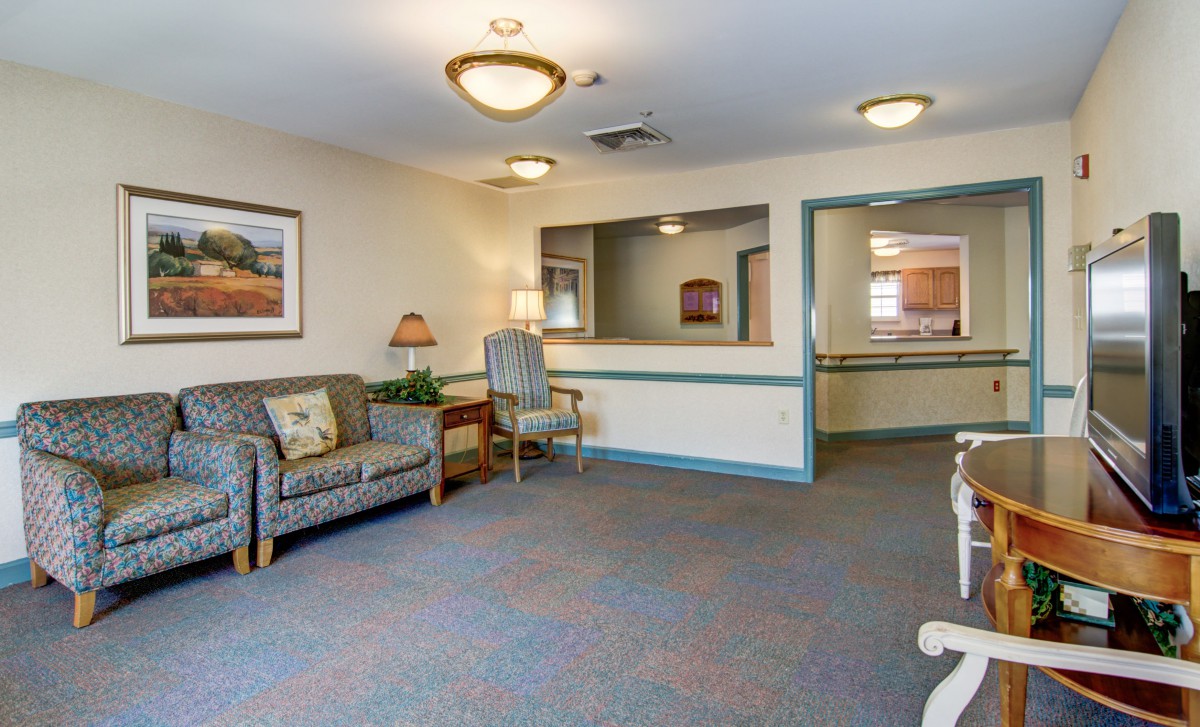 A cozy waiting area with comfortable seating and a reception desk.