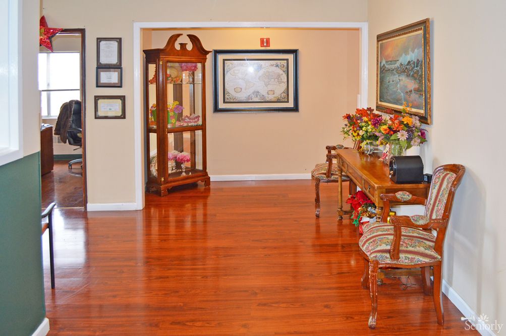 A warmly decorated hallway with wooden floors and classic furniture.