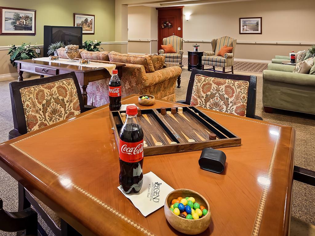 A cozy living room with a table set for backgammon and refreshments.