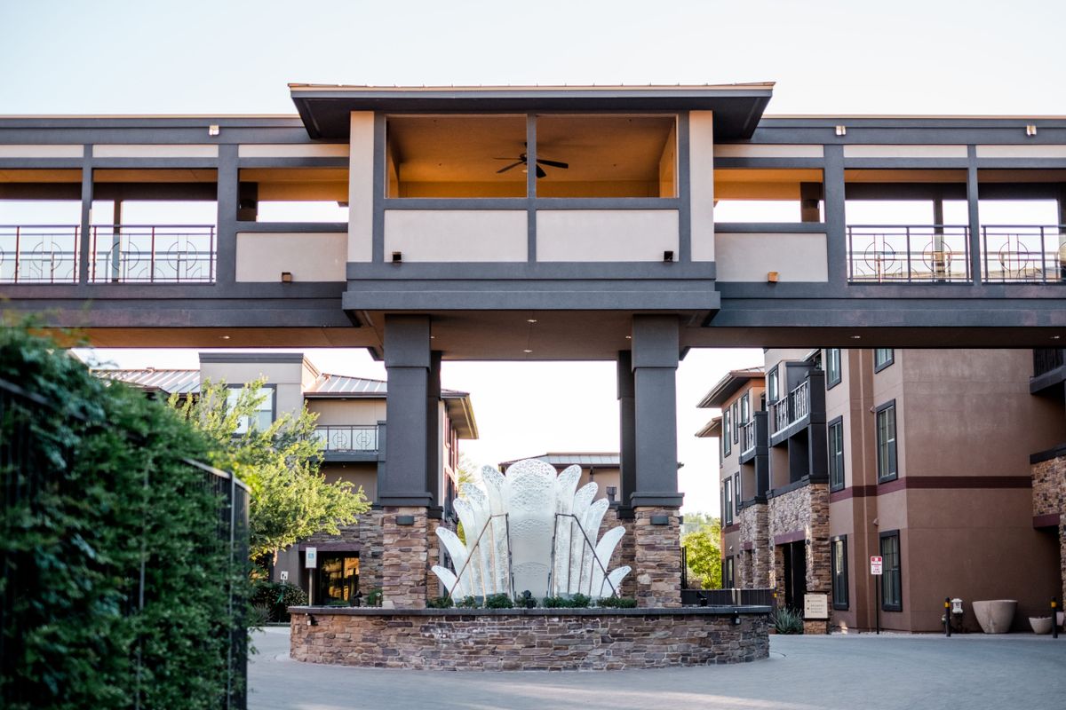 Modern commercial building with a central fountain.