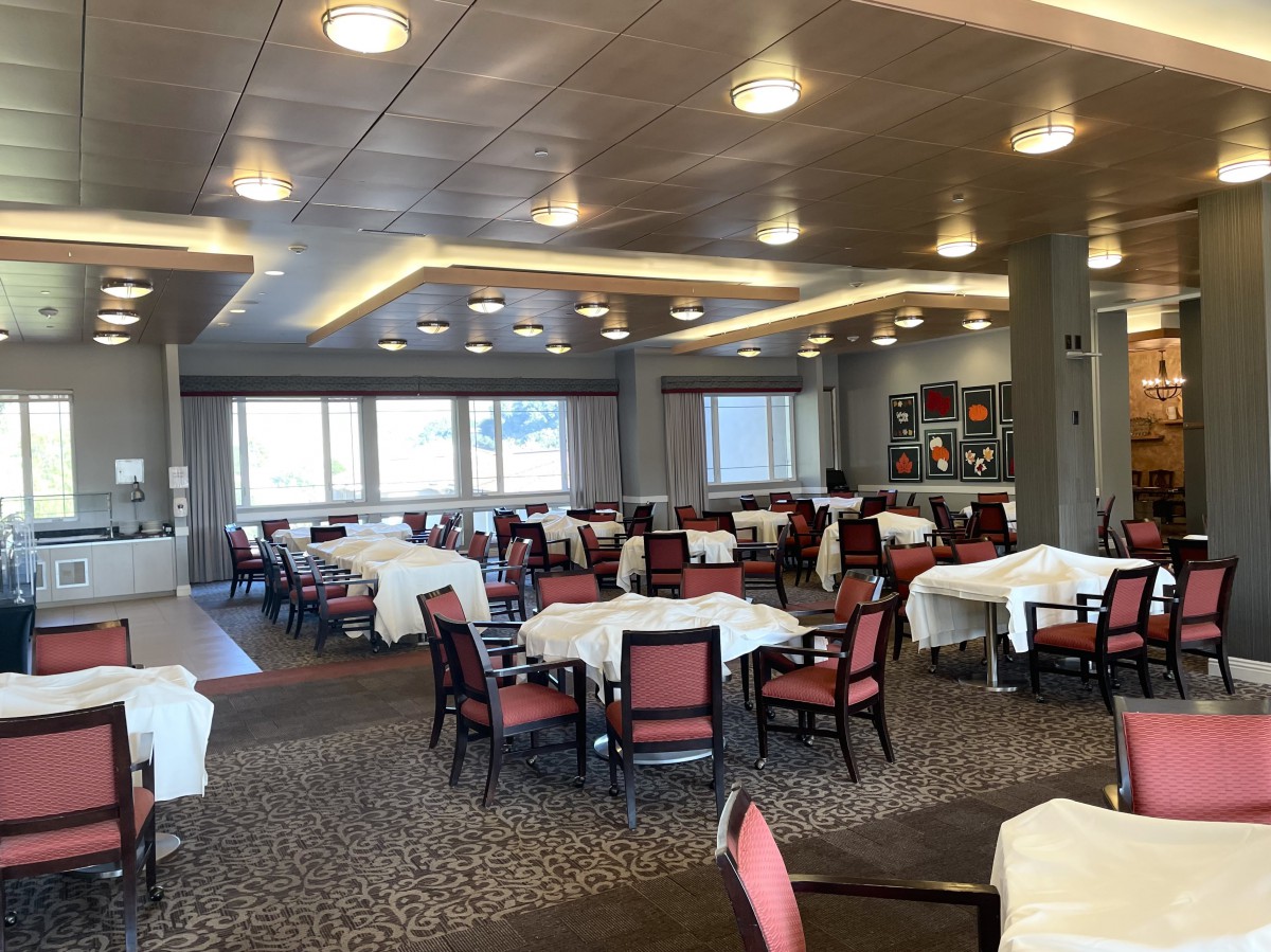 A spacious dining room with neatly arranged tables and chairs.