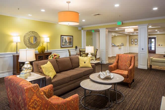 A cozy living room featuring a sofa, armchairs, and stylish decor.