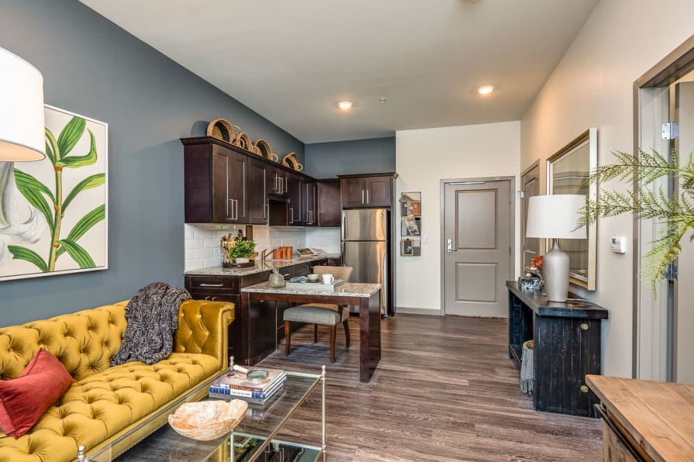 A modern apartment living area with an open-concept kitchen and stylish furnishings.
