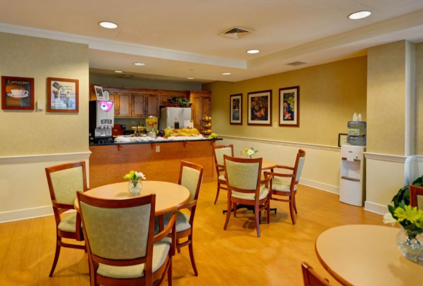 A cozy cafe dining area with tables and chairs arranged neatly.
