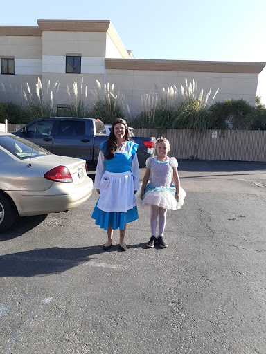 Two girls dressed in costumes, one as a classic character and the other in a fairy-like outfit, enjoying a day out.