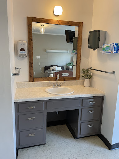 A modern bathroom vanity with a sink and mirror, featuring ample storage space.