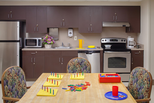 A well-equipped kitchen featuring a table with educational materials and colorful objects, perfect for engaging activities.