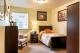 A cozy bedroom with stylish decor and ample natural light.