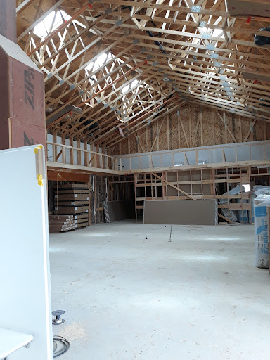 An interior view of a construction site showcasing the wooden framework and open layout.