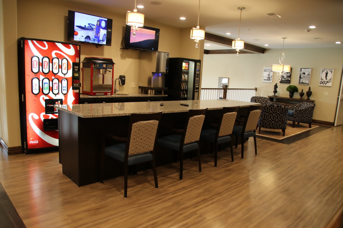A modern bar interior with seating and a vending machine.