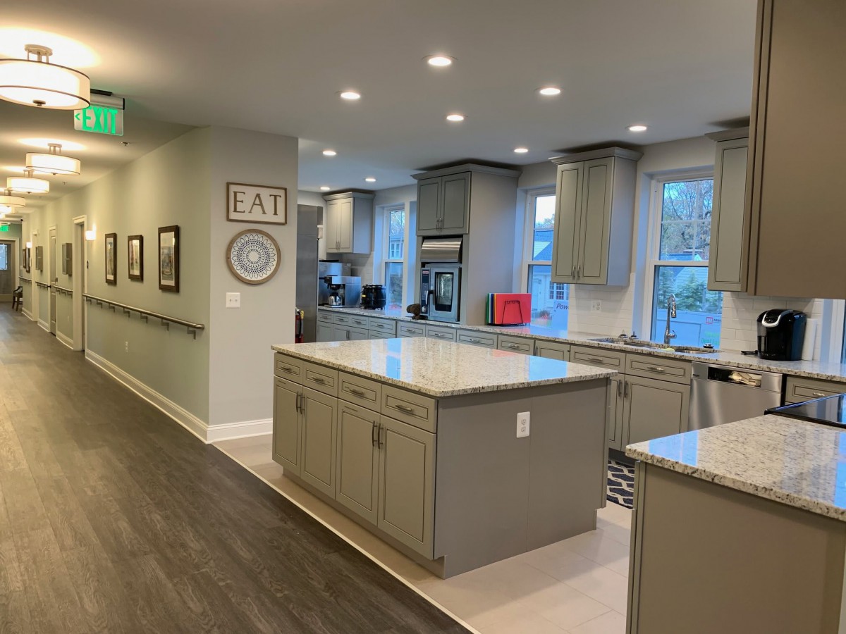 A spacious, modern kitchen with central islands and ample lighting.