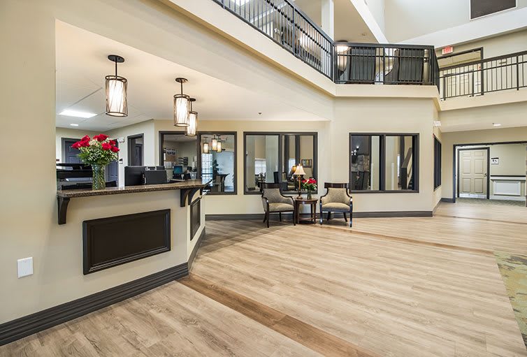 A modern lobby area featuring stylish lighting, hardwood flooring, and comfortable seating.
