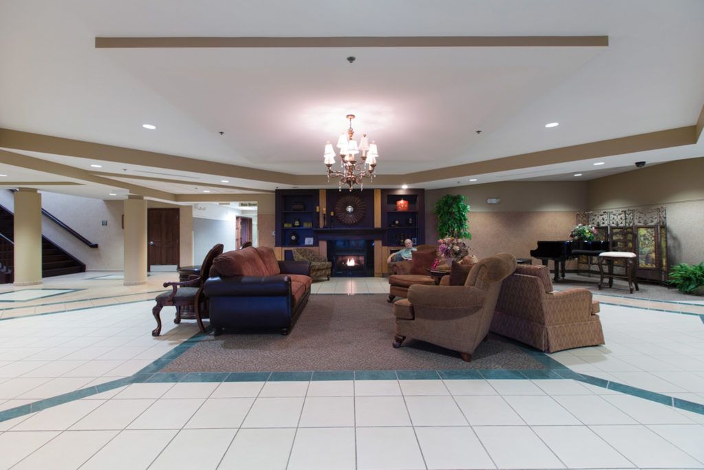 A spacious lobby with comfortable seating and a chandelier.