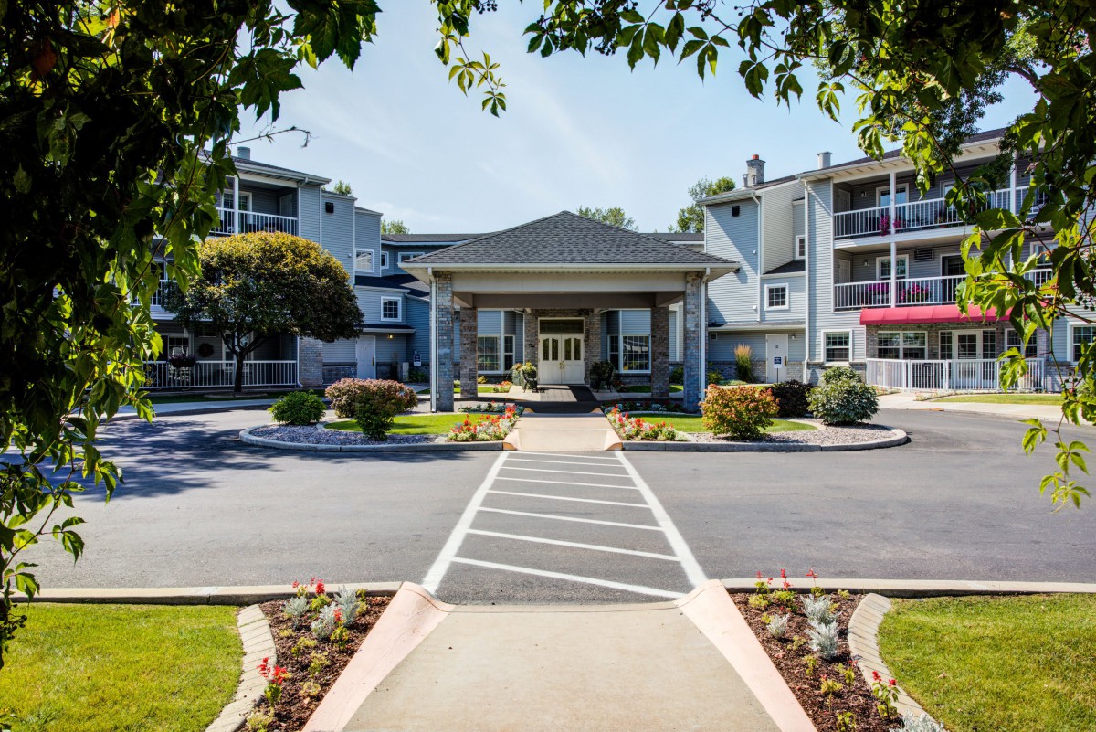 A well-maintained residential building with a central entrance and landscaped surroundings.