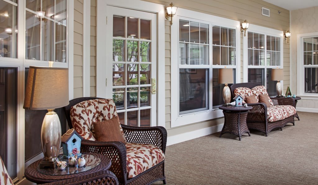 A cozy porch with comfortable seating and decorative elements.