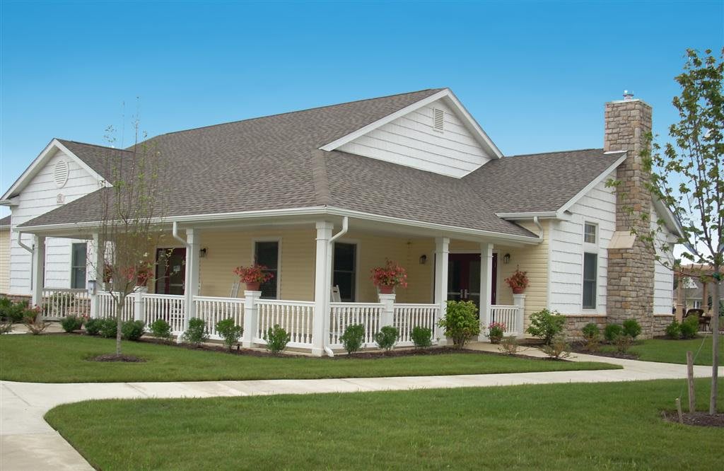 A charming suburban house with a well-maintained lawn and a welcoming front porch.