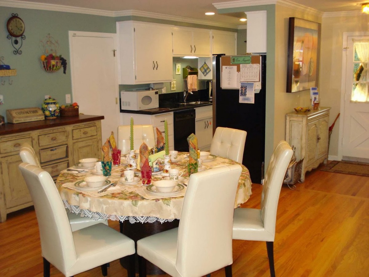 A cozy kitchen and dining area with a set table for a meal.