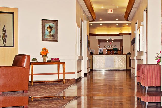 A hotel's welcoming lobby with a view of the reception desk and elegant decor.