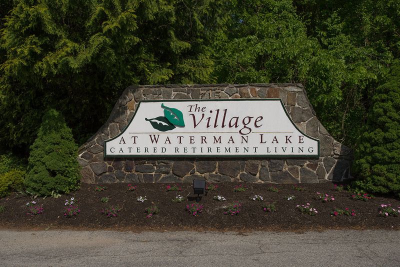 Entrance sign for The Village at Waterman Lake retirement community.