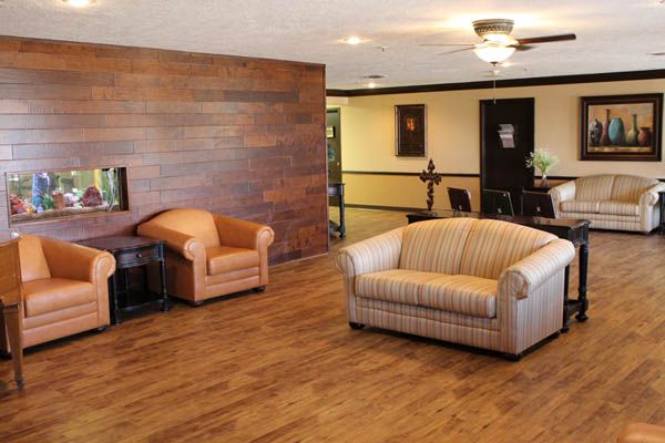 A cozy living room with wooden flooring and comfortable furniture.