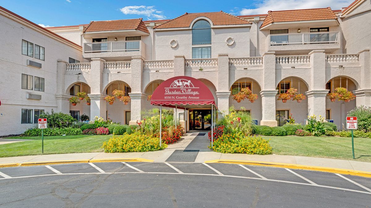A hotel building with a welcoming entrance and well-maintained landscaping.