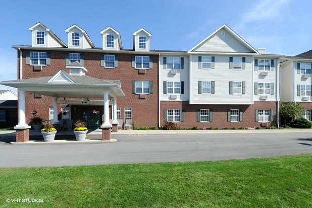 A hotel building with a prominent entrance and well-maintained landscaping.