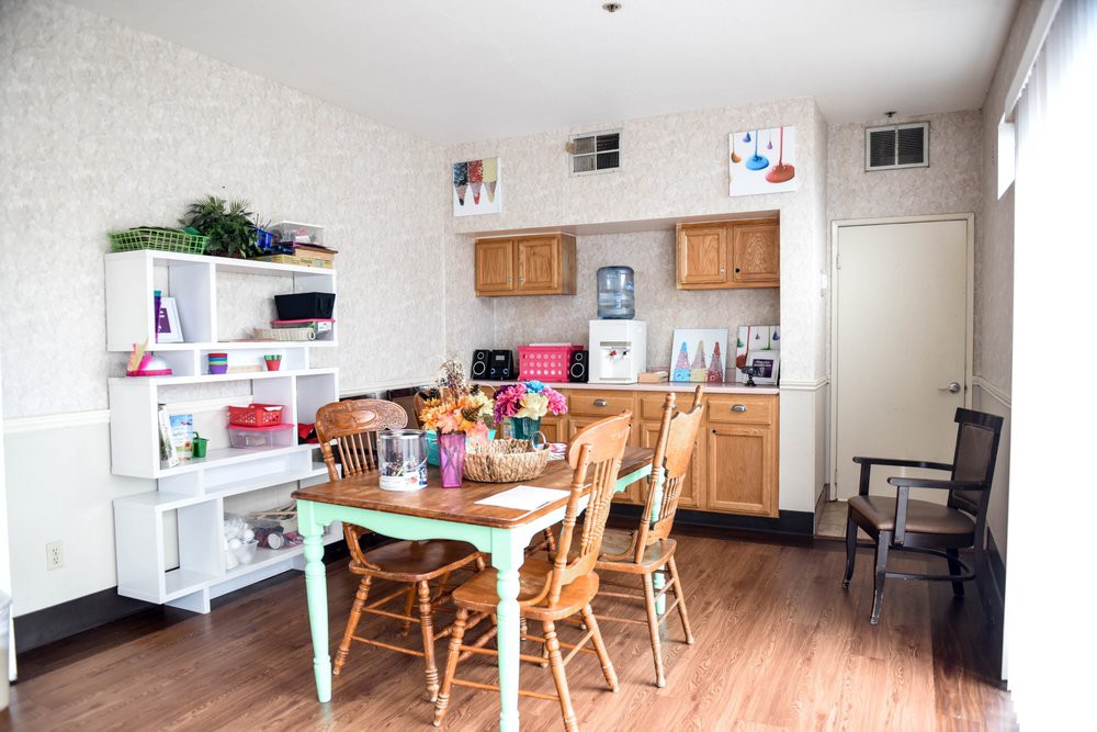 A cozy kitchen and dining area featuring wooden furniture and decorative elements.