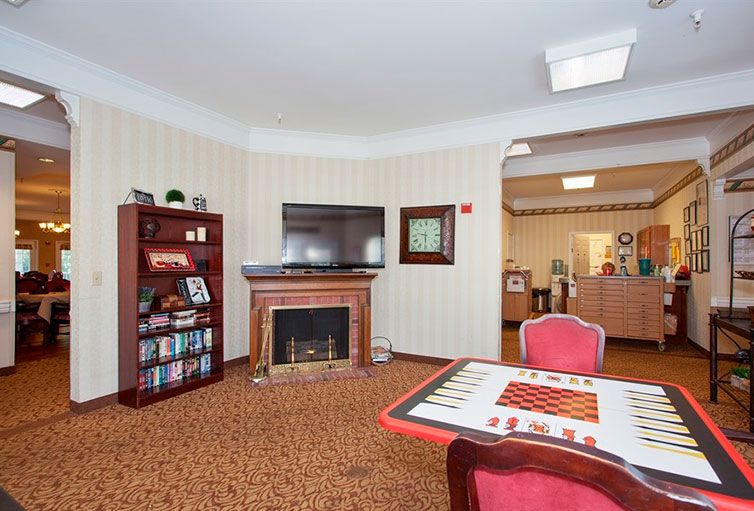 A cozy living room with a fireplace, television, and seating area.