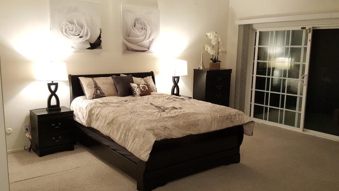 A cozy and elegantly decorated bedroom with a large bed, modern furniture, and soft lighting.