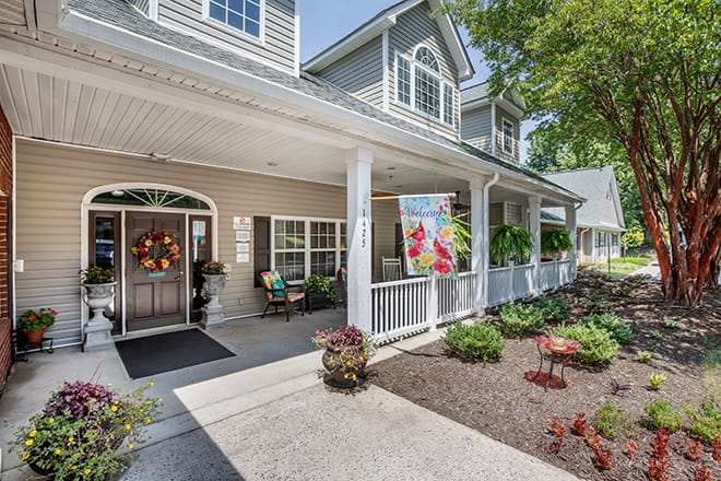 A charming house with a spacious porch and well-maintained garden.